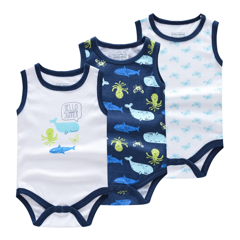 Trois Lot de 3 Bodies bébé de BABY PREMA, parfaits comme cadeau baby shower, sont présentés. Le premier est blanc avec une bordure bleu marine, un requin bleu et une pieuvre verte disant « Hello Summer ». Le second est bleu marine avec un imprimé animal marin. Le troisième est blanc avec des motifs de baleines et de crabes bleus et verts et des bordures bleu marine.