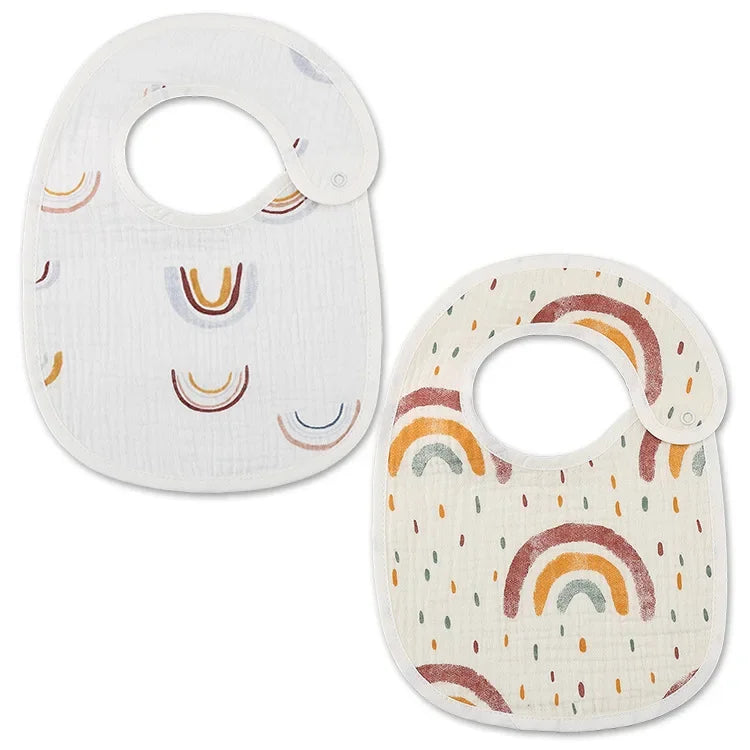 Deux bavoirs pour bébé avec fermetures à pression et style Bandana design. L’un est blanc avec des motifs arc-en-ciel unicolores et l’autre est blanc cassé avec des motifs arc-en-ciel multicolores. Ces BABY-PREMA Bavoirs Motifs Bébé 2 Pièces offrent à la fois fonctionnalité et charme à votre tout-petit.