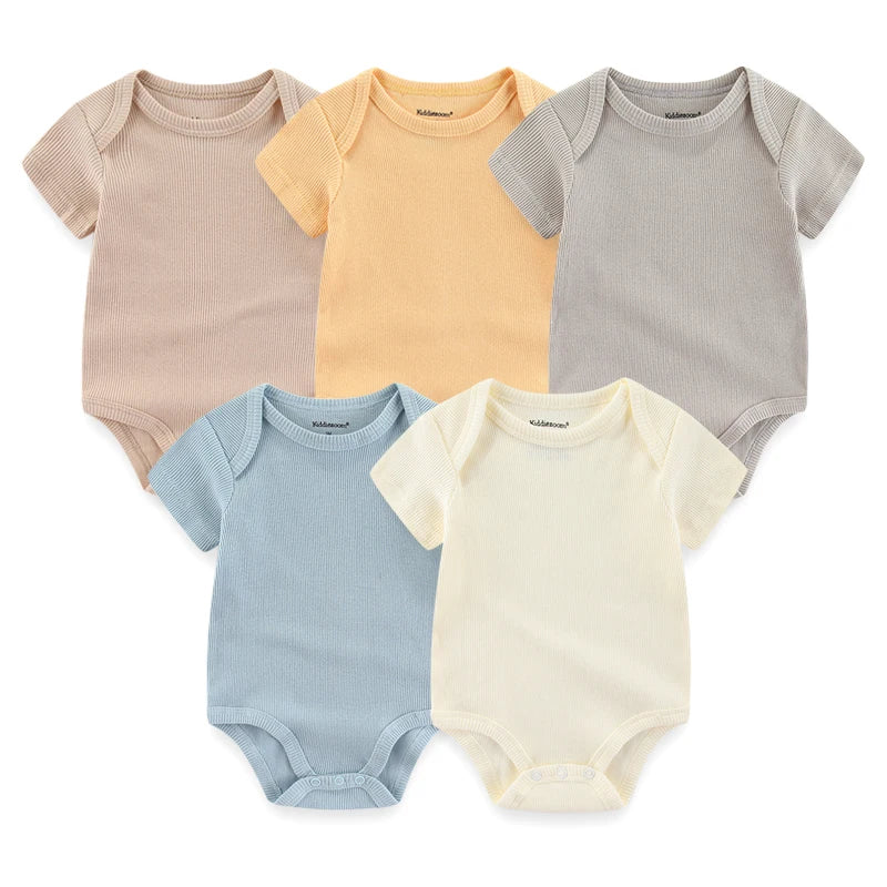Cinq grenouillères bébé de couleurs assorties (beige, orange, gris, bleu et crème) disposées sur deux rangées offrent un confort optimal. Fabriqué à partir de coton doux et doté de boutons-pression pratiques. Présentation du Lot de 5 Bodys Coton | Agréables & Conforts par BABY PREMA.