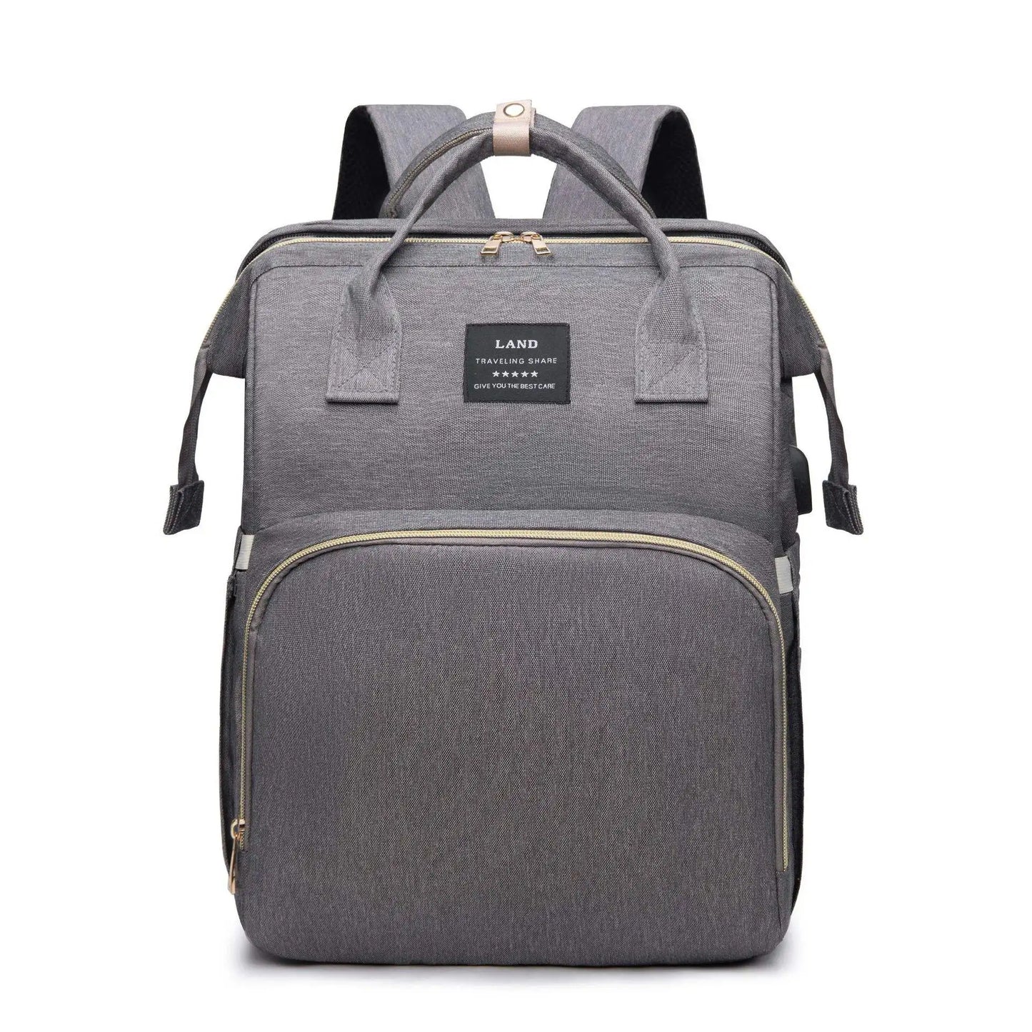 Un élégant Sac à Langer 3 en 1 Pour Maman & Bébé gris de BABY-PREMA, avec des fermetures éclair dorées, une poignée supérieure et des bretelles, sur un fond blanc. Il est conçu pour le petit enfant, alliant élégance et praticité.