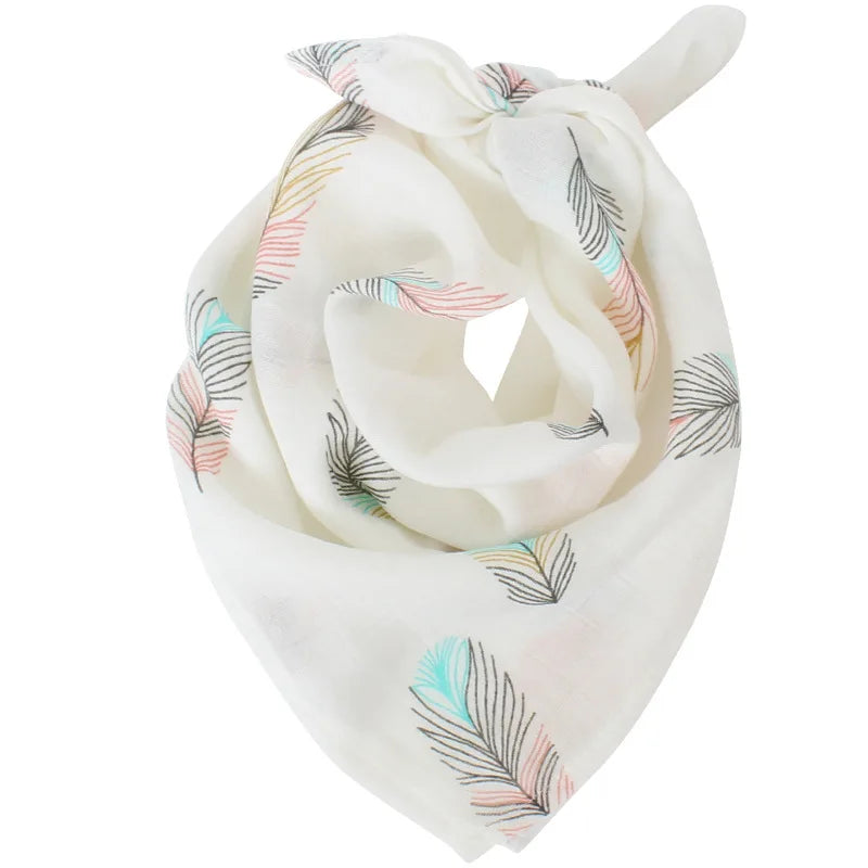 Un Lange Mousseline Coton Bio léger et blanc orné d'un délicat motif de plumes de dodo colorées de BABY PREMA.