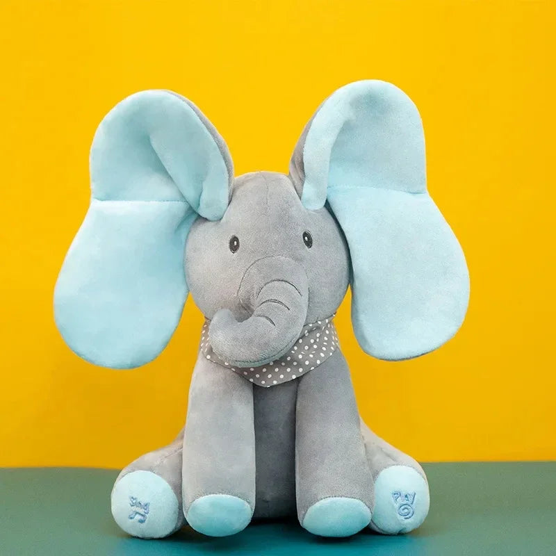 Un éléphant en peluche douce avec des oreilles bleues et une écharpe à pois conçue pour les bébés prématurés, assis sur un fond jaune.
(A jouet éléphant en peluche | chantant avec Oreilles Mobiles de BABY-PREMA)