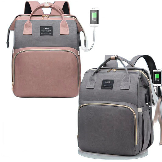 Un ensemble de deux petits sacs à dos élégants Petit Sac à Langer 3 en 1 Pour Maman & Bébé avec ports de chargement USB externes, l'un dans une combinaison de couleurs rose et grise, et l'autre dans une combinaison de couleurs gris et noir, tous deux adaptés au BÉBÉ moderne. -PREMA.