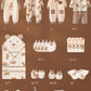 Une collection de 24 vêtements et accessoires pour bébé, dont Coffret Naissance en Coton | Nouveau-nés Douceur Assurée, dans des motifs coordonnés sur le thème de l'ours, présentés sur un fond beige chaud par BABY PREMA.
