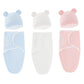 Un ensemble de trois couvertures Emmaillotage Bébé | Gigoteuse BABY PREMA aux couleurs pastel avec d'adorables capuchons à oreilles d'ours, en bleu, blanc et rose.