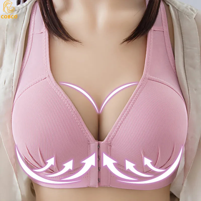 Gros plan d'un soutien-gorge de sport Soutien Allaitement Ouvert Confort sans Couture rose avec des flèches graphiques blanches indiquant les caractéristiques de portance et de maintien, conçu avec un matériau poids léger pour plus de confort par BABY PREMA.