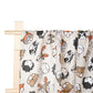 Un rideau fantaisiste décoré d'illustrations ludiques de divers animaux dans un style artistique de griffonnage, drapé sur une simple tringle en bois sur un fond blanc, parfait pour un BÉBÉ PREMA Lange d'Emmaillotage Couverture | 100% Coton pour la chambre de Bébé.