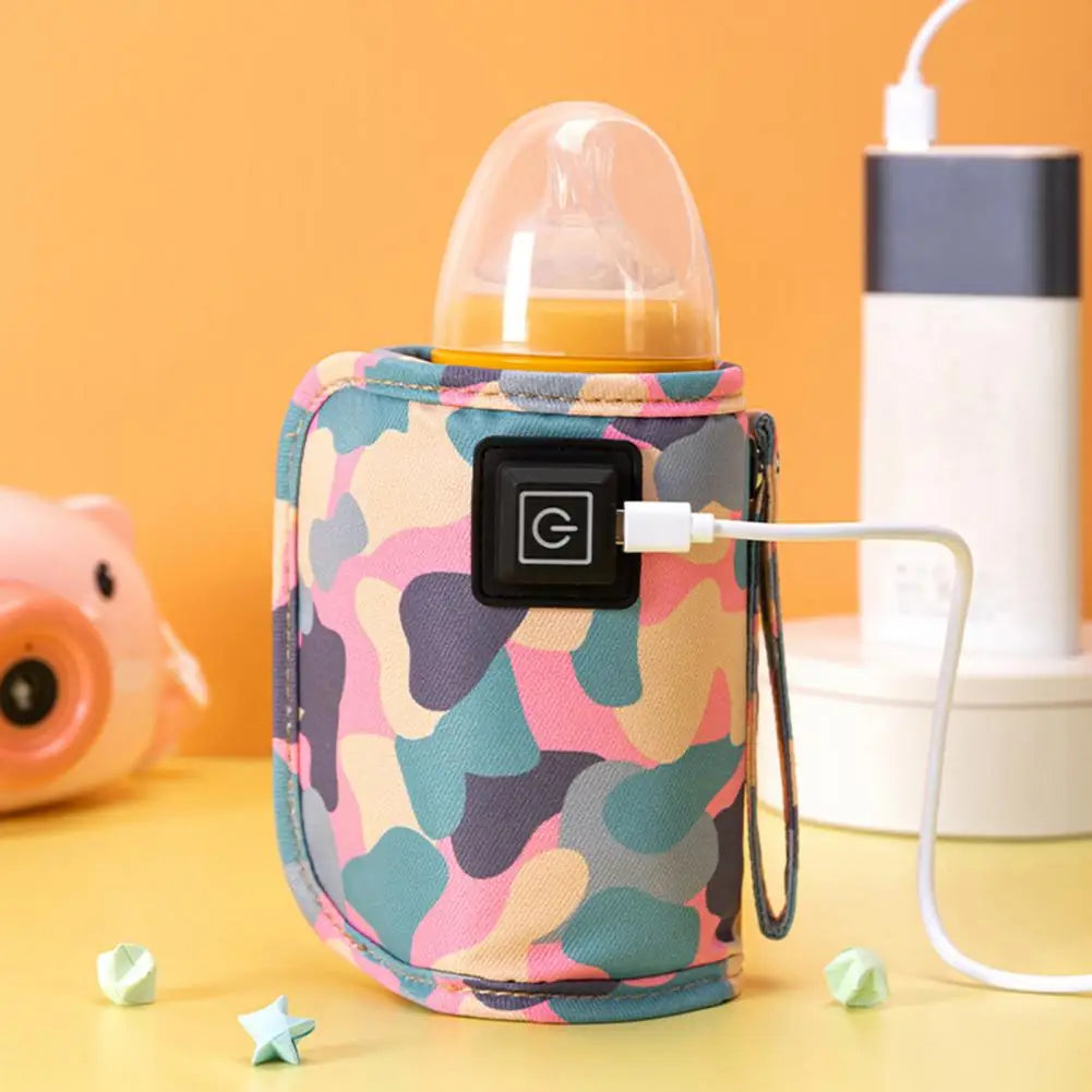 Un BABY-PREMA Chauffe-Biberon Portable Intelligence Résistant dans une pochette colorée à motif camouflage se branche avec un câble USB. Il est placé sur une surface jaune avec une tirelire de couleur pêche et un dispositif cylindrique blanc et noir en arrière-plan. De petites étoiles en papier vert sont disséminées un peu partout, idéales pour les parents occupés.