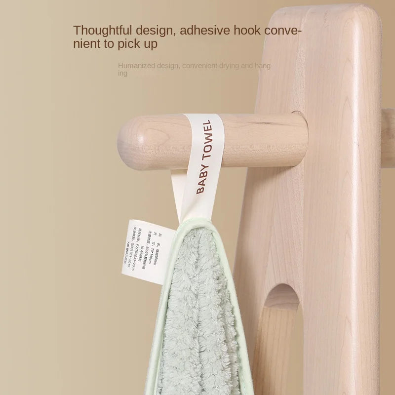 Support en bois BABY PREMA élégant et minimaliste, parfait pour une chambre de bébé, avec crochet adhésif pratique pour accrocher facilement les serviettes - un mélange de fonctionnalité et de design moderne.