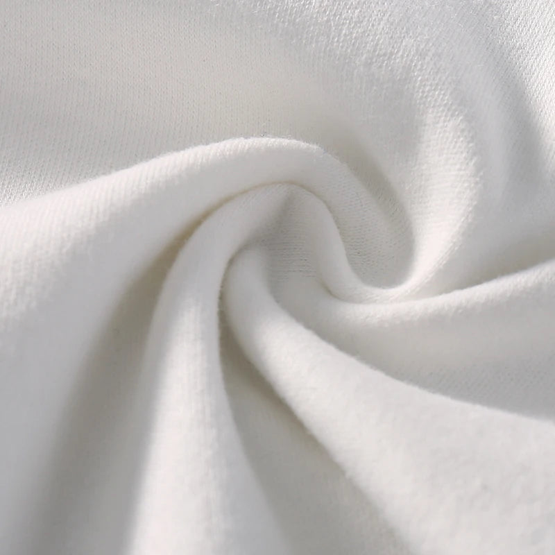 Image en gros plan d'un tissu blanc, comme celui utilisé dans BABY-PREMA Body coton Manches Longues, torsadé en un motif en spirale. La texture du tissu semble douce et lisse.