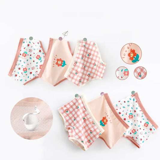 Un ensemble de cinq paires de sous-vêtements pour fille dans divers motifs floraux, à carreaux et unis, disposés en rangée. Ce *Lot de 3 Culottes pour Enfants* de *BABY PREMA* d'une confection exquise est fabriqué à partir de coton doux pour un confort ultime.