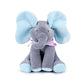 Un jouet doux et moelleux BABY-PREMA Doudou Eléphant Peluche Musicale avec des oreilles bleu ciel et des pieds assortis, orné d'un joli nœud à pois violets, repose sur un fond blanc, prêt pour les câlins d'un bébé.